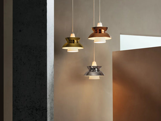 Modern smart home interior featuring voice-controlled Scandinavian pendant lights in metallic finishes by Louis Poulsen, creating warm luxury ambiance with contemporary European design.