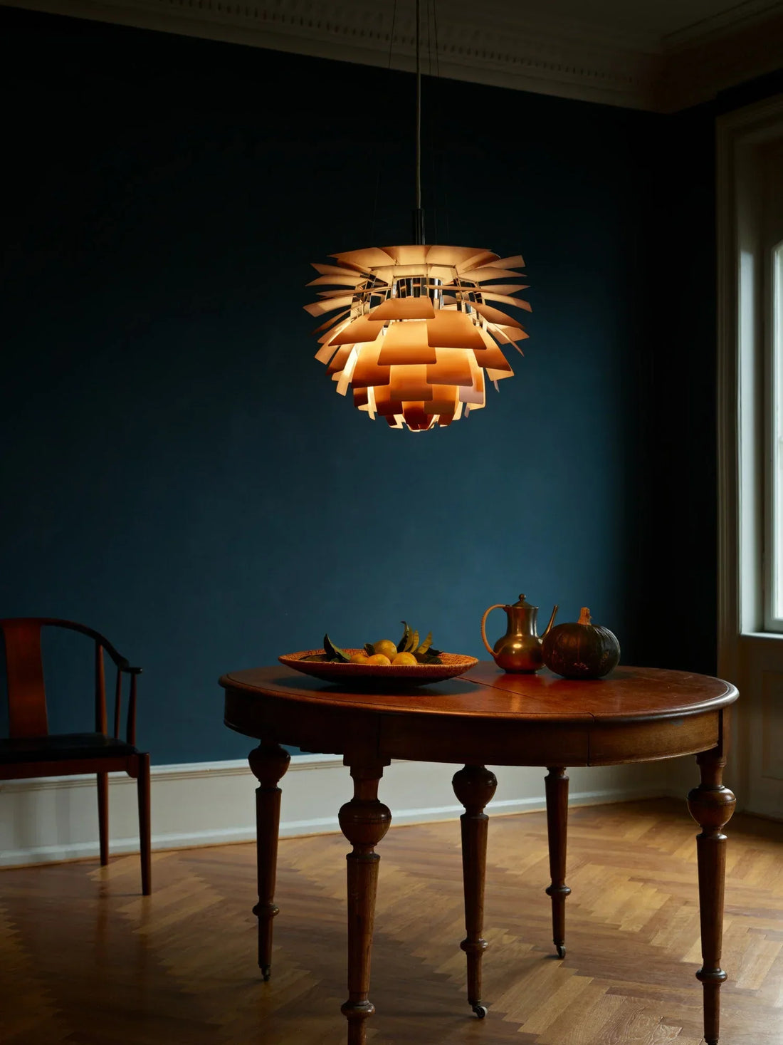 Elegant foyer featuring a statement chandelier, wall lamps, and warm layered lighting creating a luxurious and welcoming entrance.