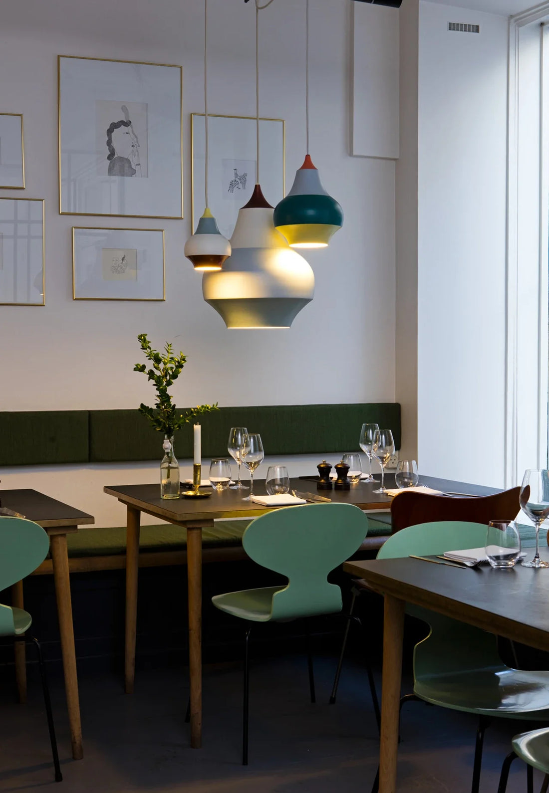 Festive Indian dinner table illuminated with warm pendant and candlelight creating an inviting, luxurious atmosphere.