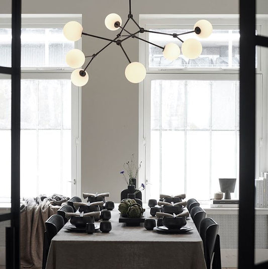 Drop Chandelier Bulb by 101 Copenhagen featuring multiple adjustable arms and exposed bulbs in a sculptural design for modern living spaces.