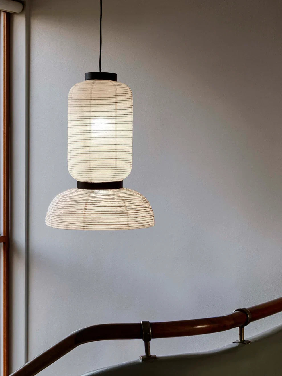Sculptural paper pendant light creating a soft warm glow in a modern Scandinavian interior