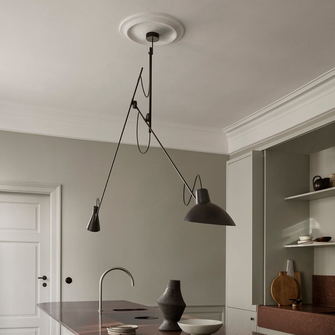 Stylish pendant lights hanging over a modern kitchen island in a contemporary home setting.