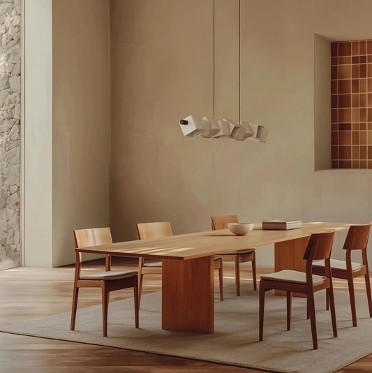 Elegant dining room with a dimmable designer pendant above a dining table, creating warm ambient lighting in a sophisticated modern interior.