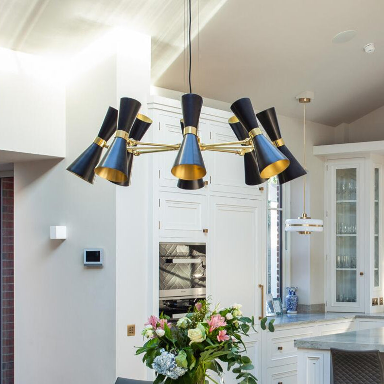Modern kitchen with a stylish chandelier, dining table, and chairs.