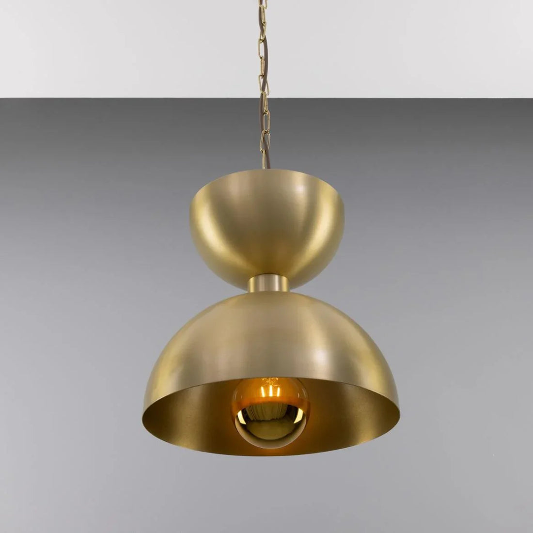 Pooja room with warm accent lighting, soft wall lamps, and subtle overhead pendant creating a calm and spiritual ambience.