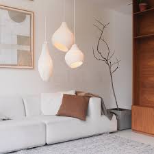 Efficient use of layered lighting in a modern living room with luxury decorative light fixtures, including wall lamps, floor lamps, and hanging pendants.
