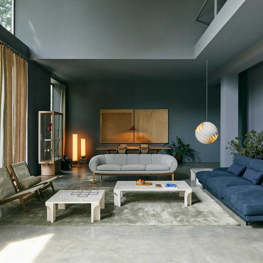 Serene meditation corner featuring warm Scandinavian designer lighting, soft wall lamps, elegant floor lamp, and calming minimalist interior for mindful relaxation.