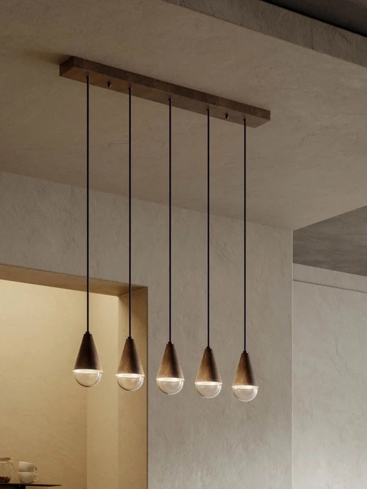 Dark entryway runner illuminated with warm wall lamps, pendant lighting and layered fixtures, creating a welcoming and elegant entrance.