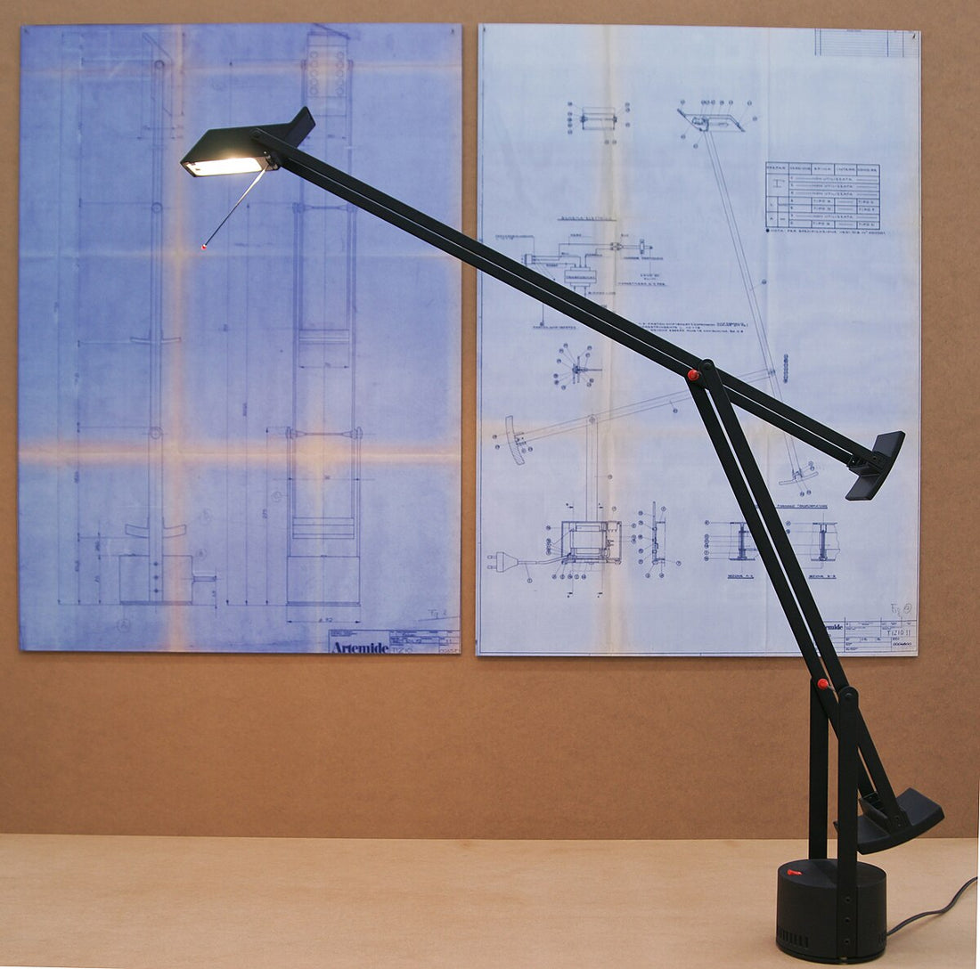 Alt Text: Tizio Lamp by Richard Sapper featuring a sleek, matte black frame with adjustable arms and counterweights.