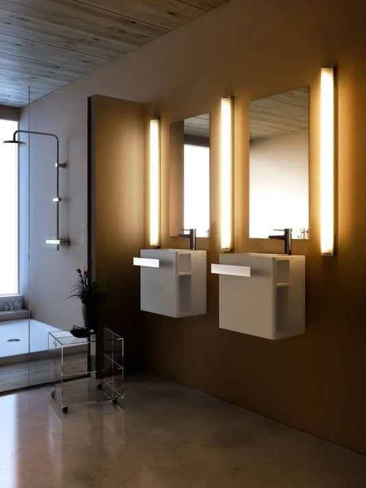 Bathroom illuminated by wall lights and soft ambient lighting, creating a luxurious spa-inspired contemporary bathroom.