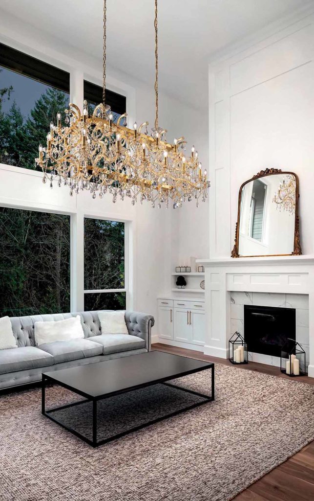 Crystal chandelier being gently cleaned with a microfiber cloth, showcasing sparkling crystals in a luxurious interior setting.
