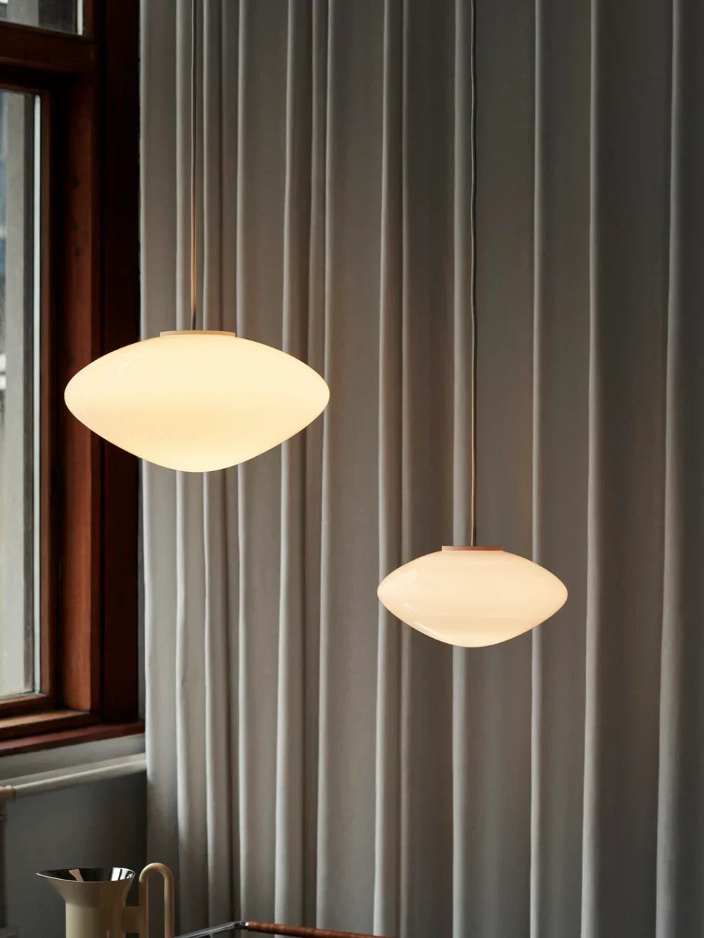 &Tradition Mist Pendant Lamp AP15, a modern round luxury lamp made from mouth-blown opal glass, illuminated with warm diffused light