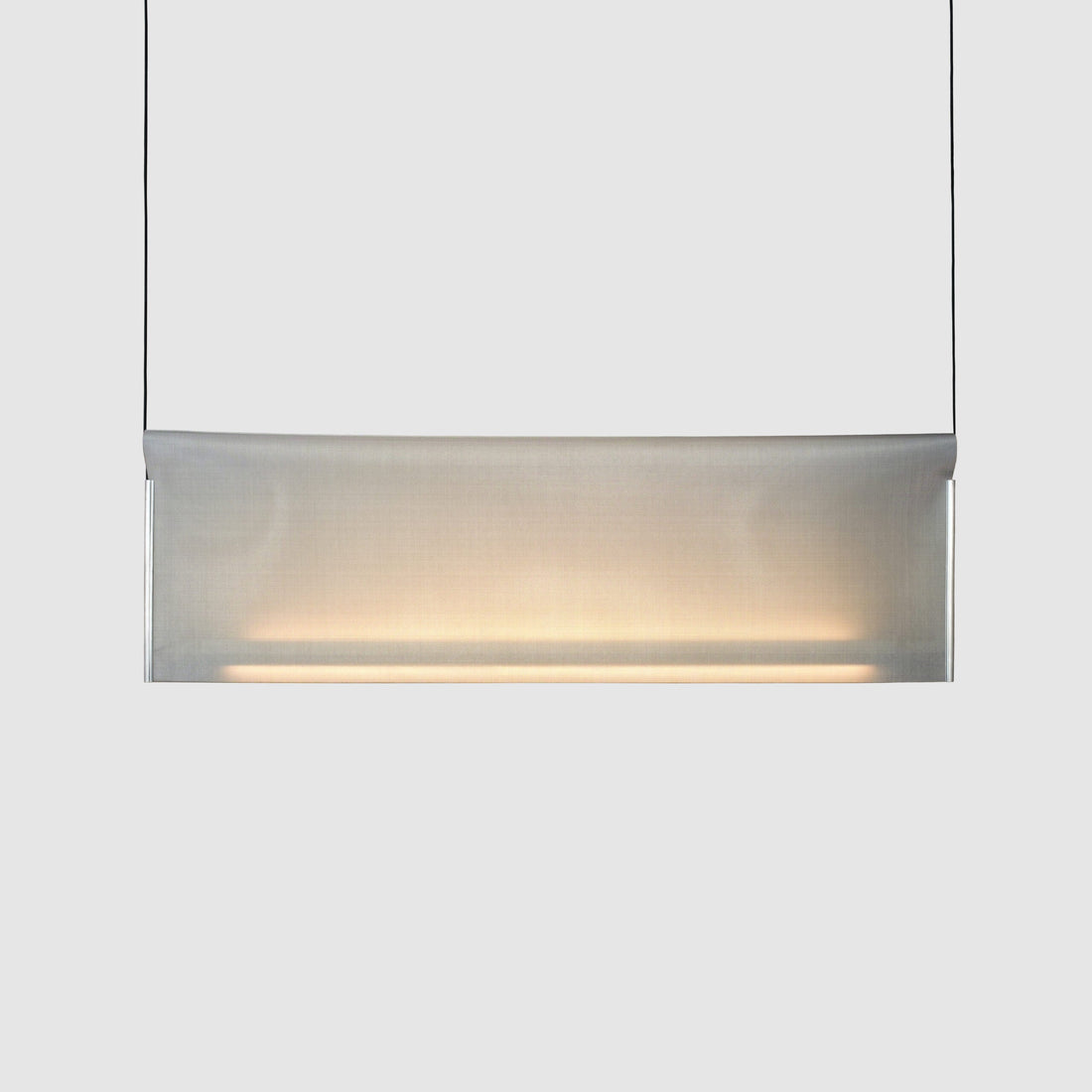 Nebra Pendant Lamp by A Emotional Light, linear stainless steel mesh pendant emitting soft ambient and direct light in a modern interior.