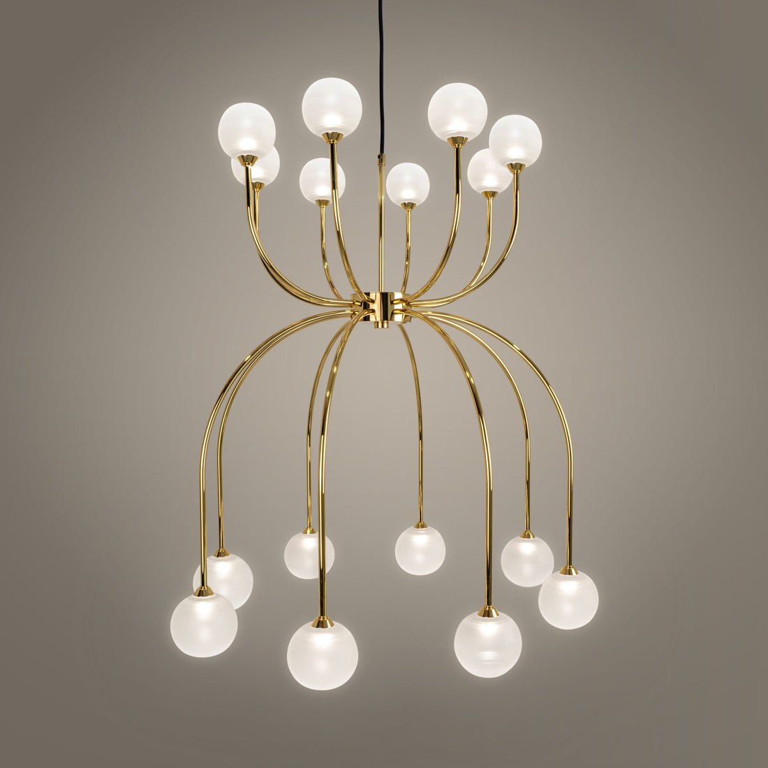 Modern living room featuring brushed brass pendant lights and gold-toned wall lamps styled with neutral interiors.