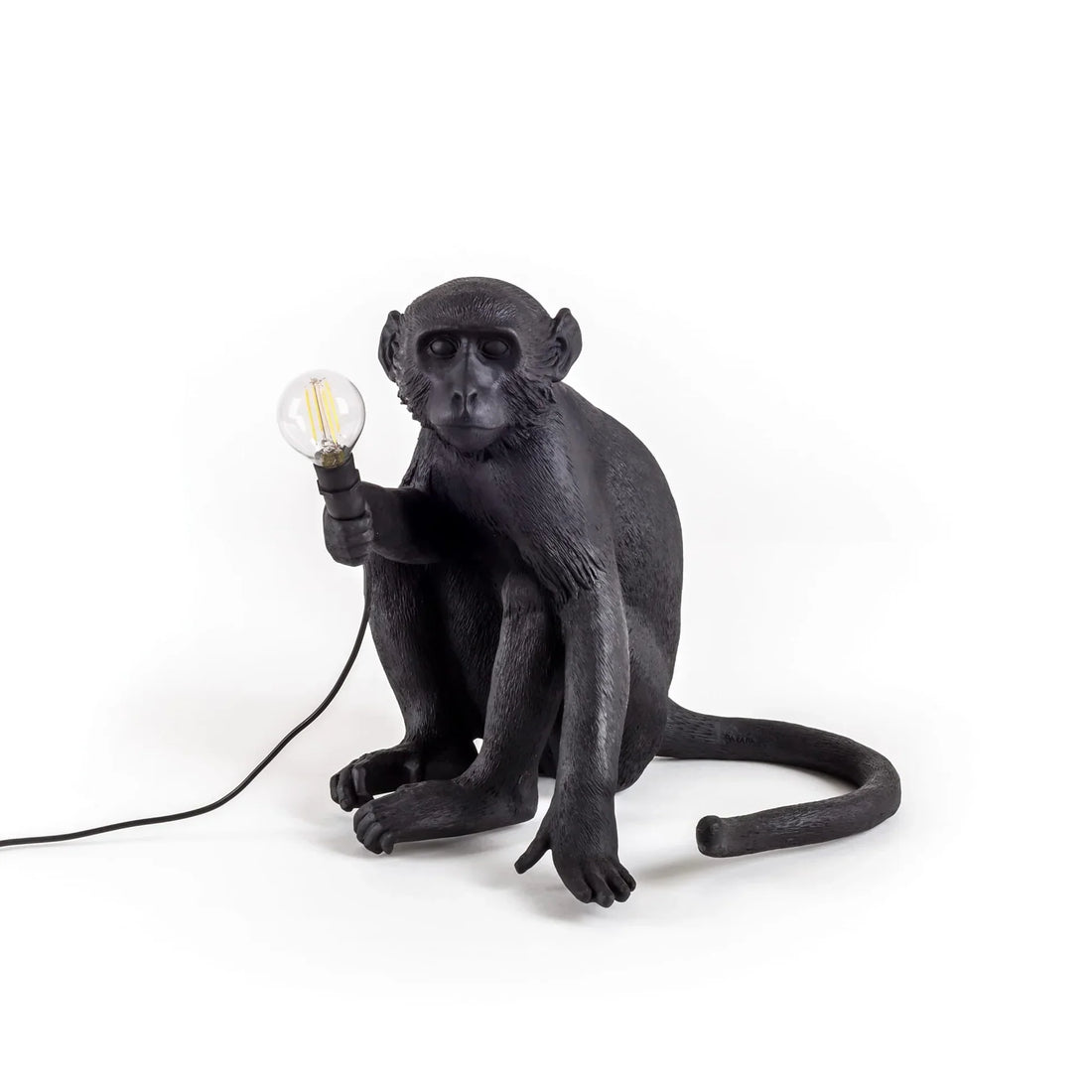 Monkey Lamp holding a bulb in hand – "Playful Monkey Lamp by Marcantonio for Seletti, combining humor and functionality in home lighting."