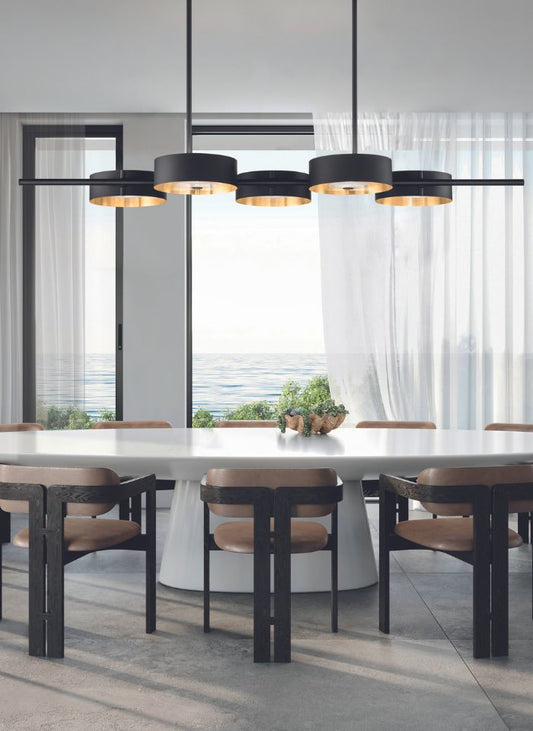 Elegant contemporary dining room featuring a sculptural linear chandelier above a long dining table, with premium European lighting and sophisticated interiors.