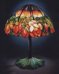 Tiffany Lamp with stained glass shade on a wooden console, casting colorful ambient light.