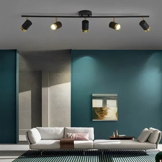 Modern magnetic track lighting system with adjustable spotlights illuminating a contemporary luxury living room.