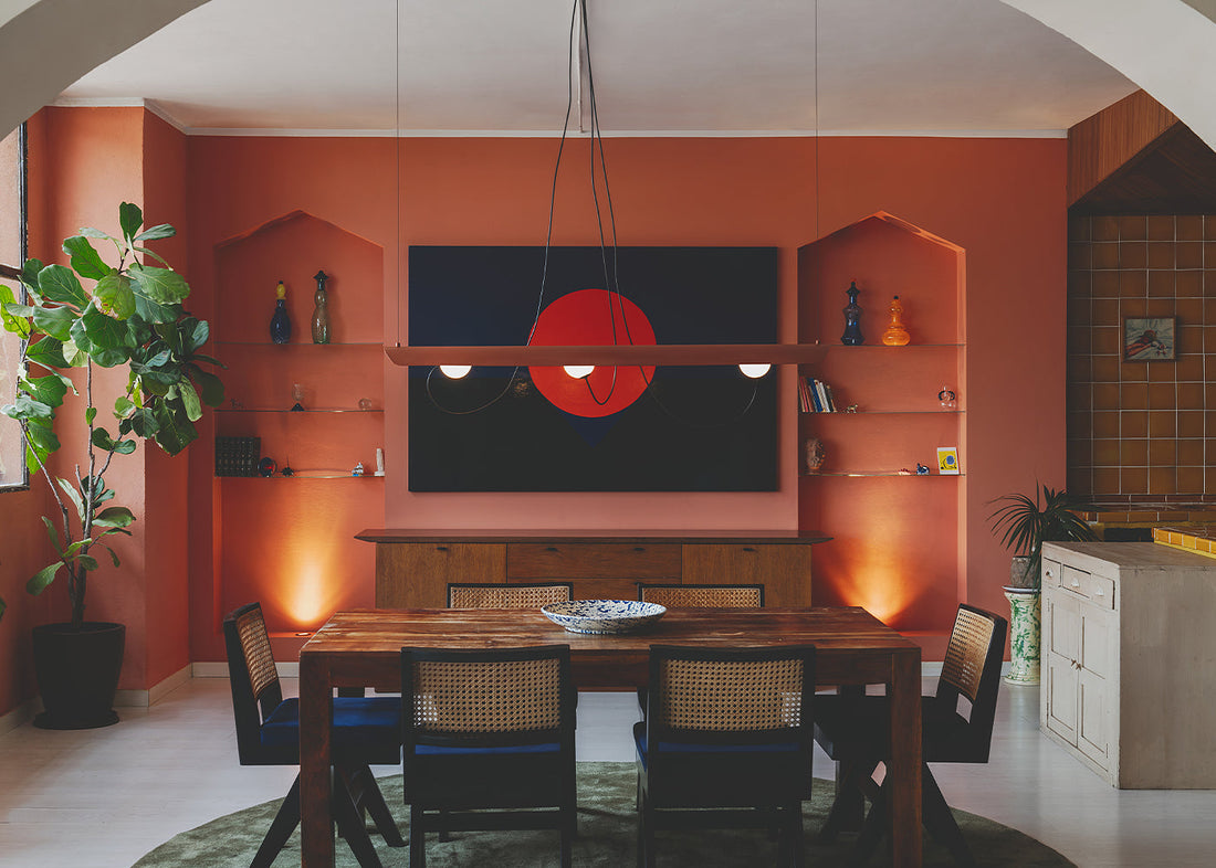 Elegant dining room with fancy hanging lights from premium lighting brands in India creating a perfect ambiance.