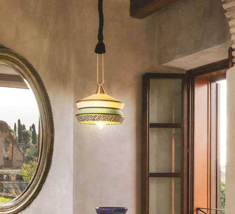 Boho-style living room with layered lighting featuring rattan pendants, wall lamps, and cozy home decor lights