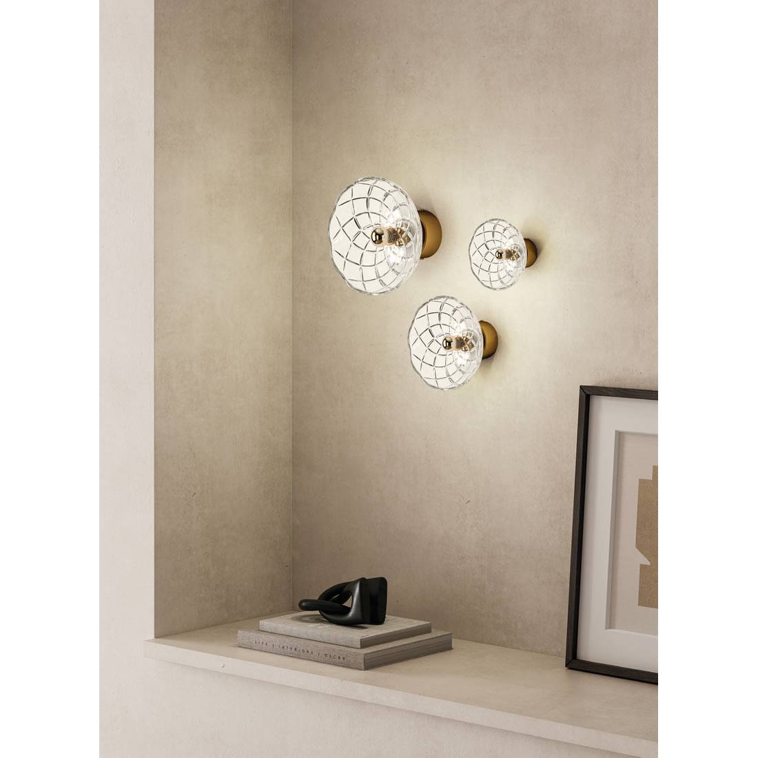 Small apartment interior with layered lighting using wall lamps, hanging pendants, and floor lamps to create a spacious, well-lit look.