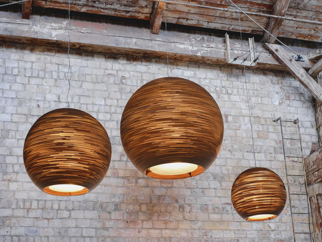 Modern interior featuring sustainable LED pendant lights with warm glow and minimalist eco-friendly design elements.