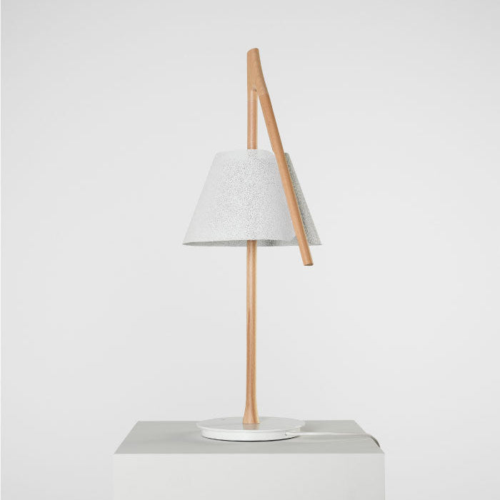 Cambo Table Lamp by A Emotional Light with beech wood structure and stainless steel mesh shade, softly glowing on a modern table.