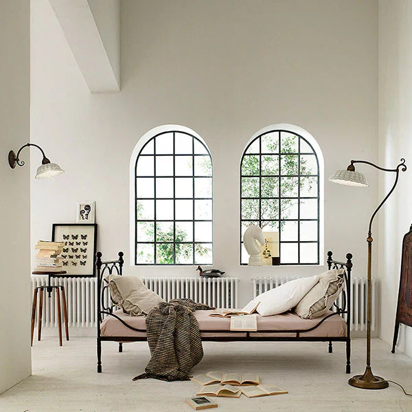 Cozy living room with floor lamps for living room and wall lamps from premium lighting brands in India.