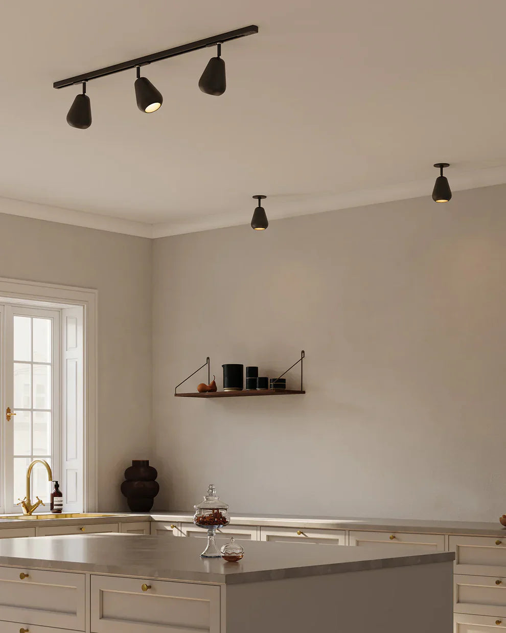 Modern kitchen illuminated with pendant and recessed lighting, creating a sleek and functional atmosphere