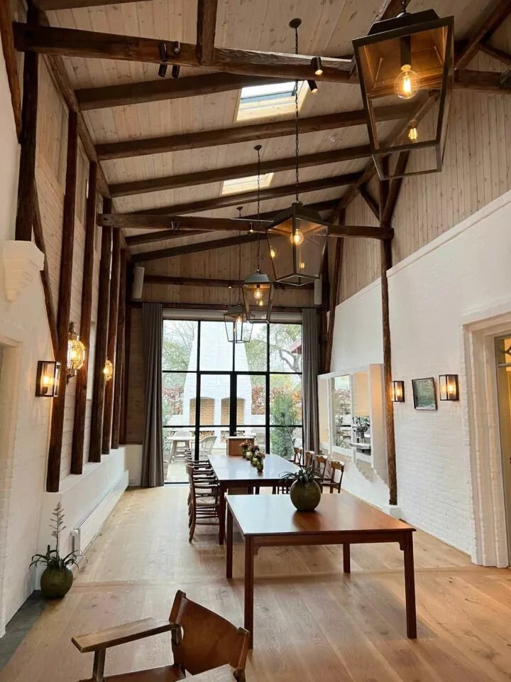 Living room with chandelier, wall lamps, and floor lamp following the rule of thumb for layered lighting.