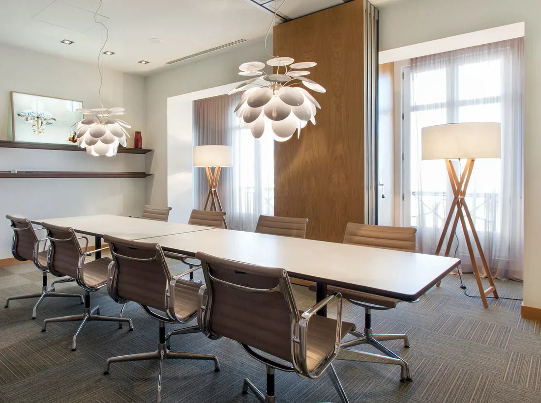 Layered interior lighting featuring ambient ceiling lights, task floor lamps, and accent hanging pendants in a modern living room.