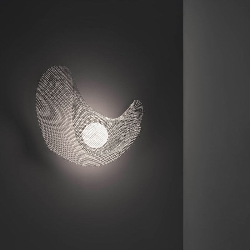 Mytilus Wall Lamp by A Emotional Light in white stainless steel mesh, ocean-inspired sculptural wall light glowing softly indoors.