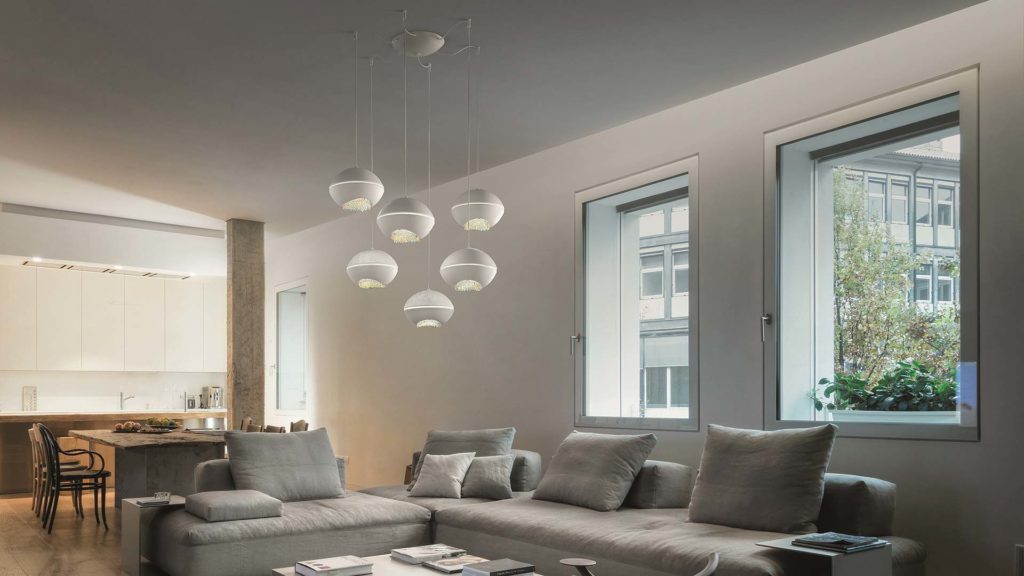 Masiero Pendant Light hanging in a living room with grey sofas with soft and minimal interior feels 