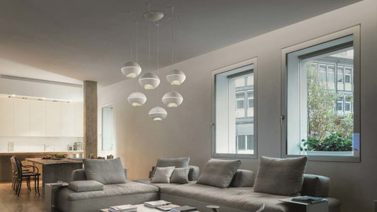 Masiero Pendant Light hanging in a living room with grey sofas with soft and minimal interior feels 