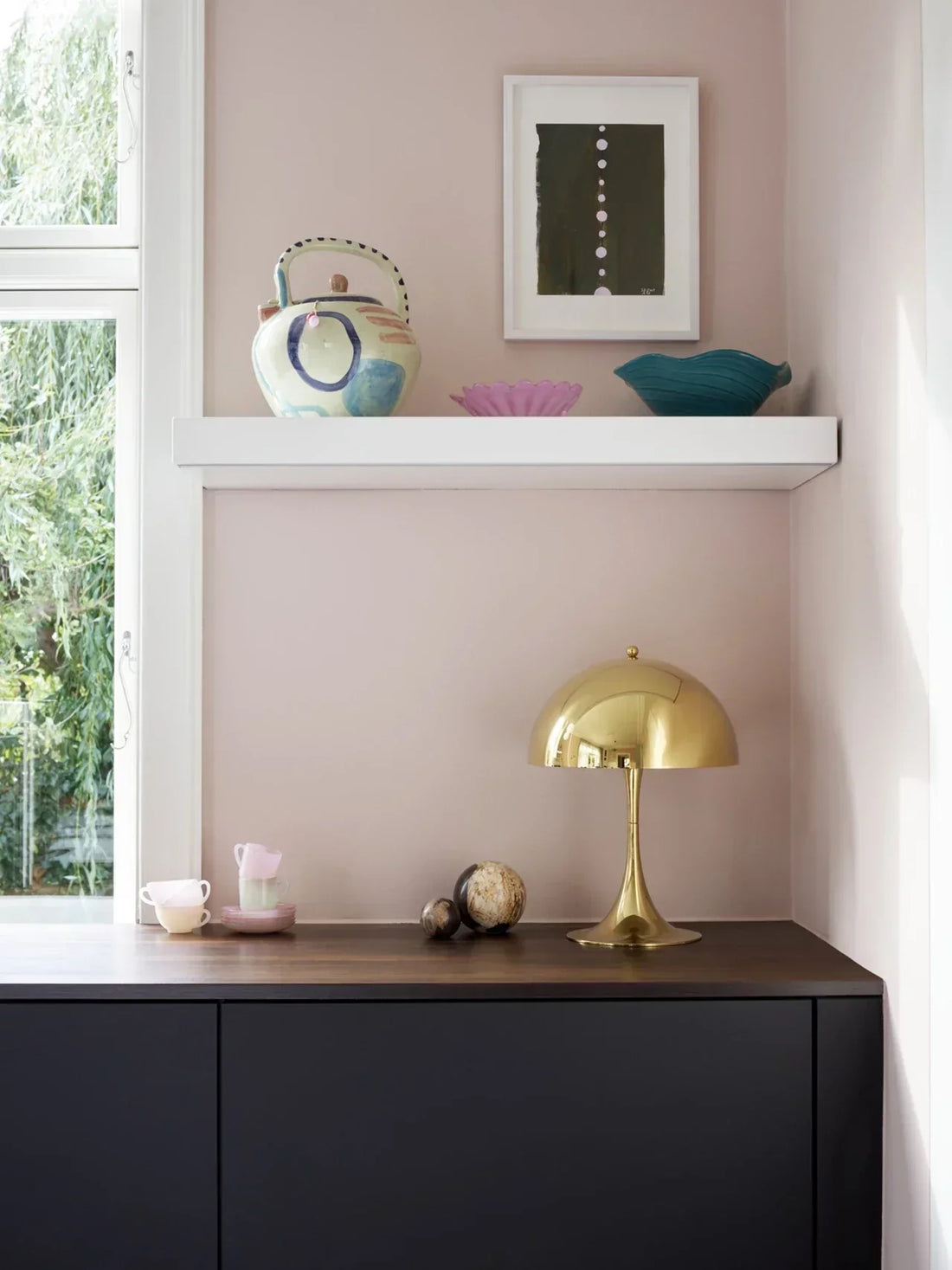 Interior featuring matte black pendant lights and brushed gold wall lamps showcasing contrasting modern lighting finishes.