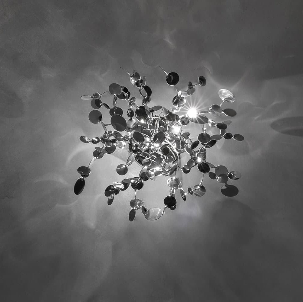 Argent wall lamp by Terzani featuring sculptural stainless steel discs with soft shimmering glow, Italian luxury wall light for modern interiors.