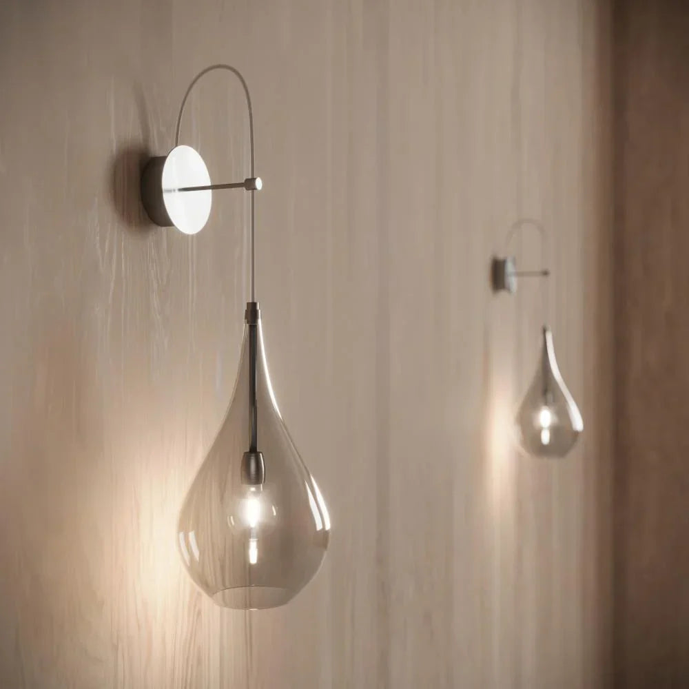 Modern interior featuring sculptural pendant lights, warm layered lighting, and minimalist Scandinavian-inspired fixtures.