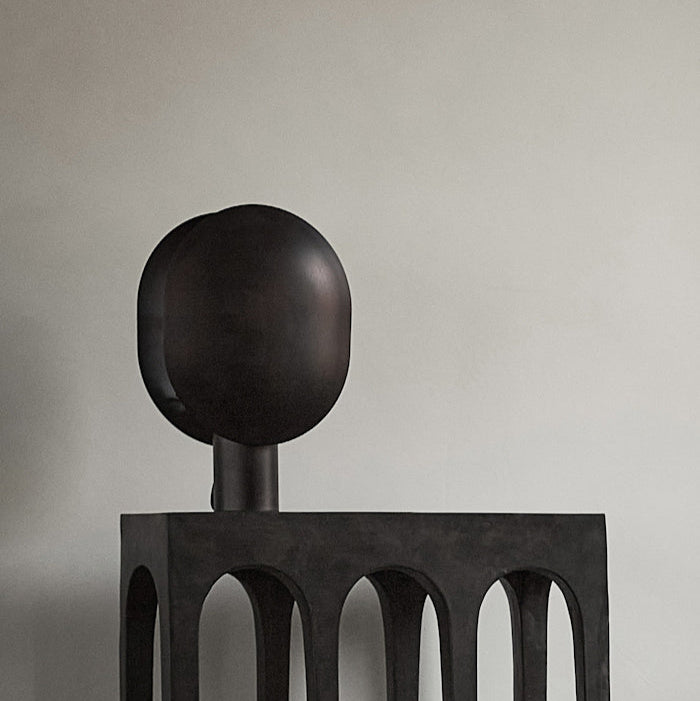 Clam Table Lamp by 101 Copenhagen styled on a side table in a Scandinavian-inspired living room with soft ambient lighting.