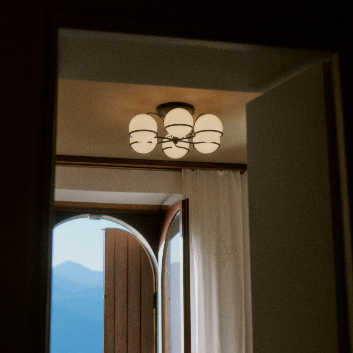 Astep Model 2042/6 Ceiling Lamp featuring six opaline glass globes arranged on an elegant brass frame, delivering mid-century style and soft ambient light.