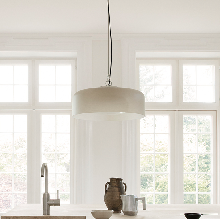 Astep Model 2050 Suspension Lamp featuring a lightweight disc-shaped diffuser in opaline glass, suspended by sleek brass rods for a modern, airy look.