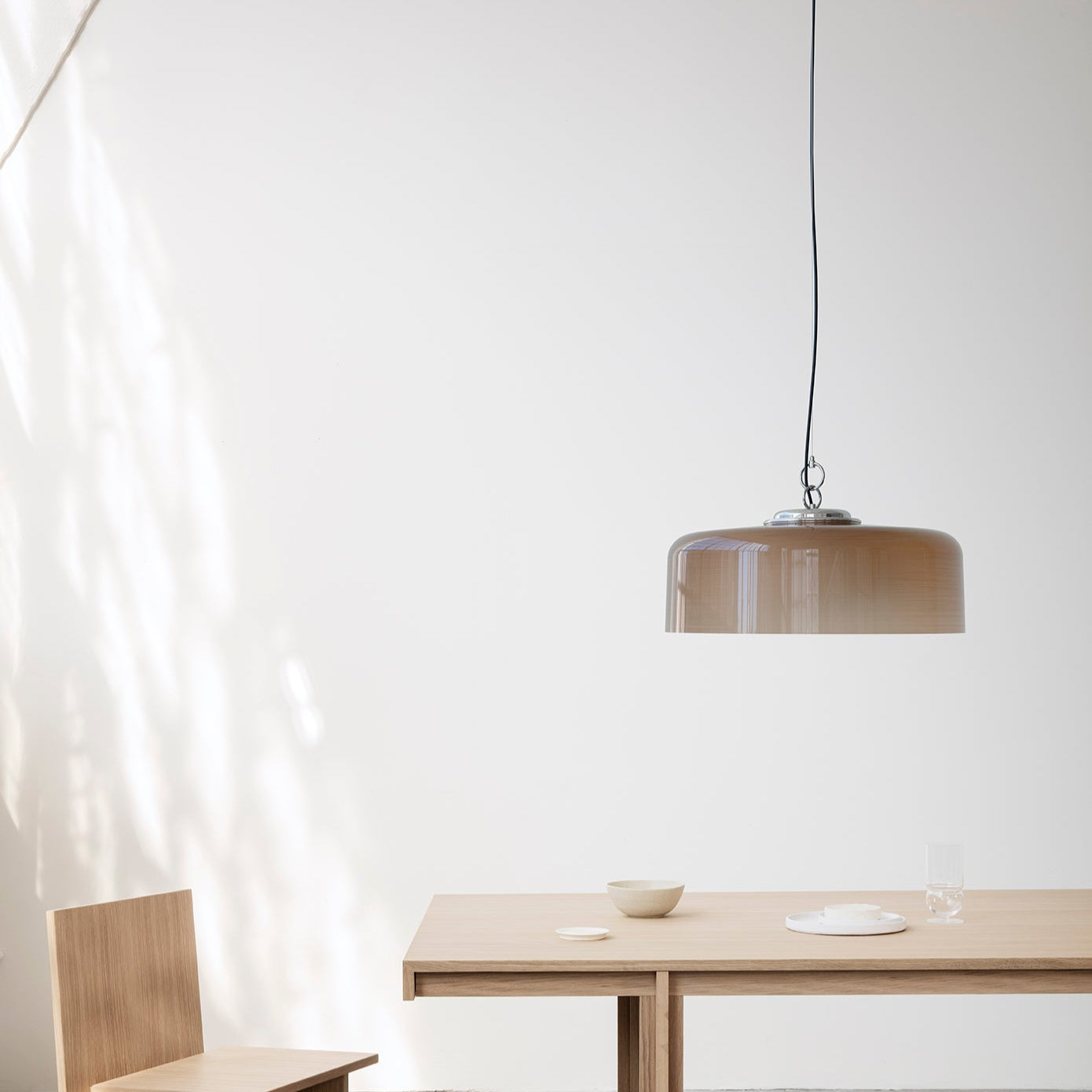 Astep Model 2050 Suspension Lamp featuring a lightweight disc-shaped diffuser in opaline glass, suspended by sleek brass rods for a modern, airy look.