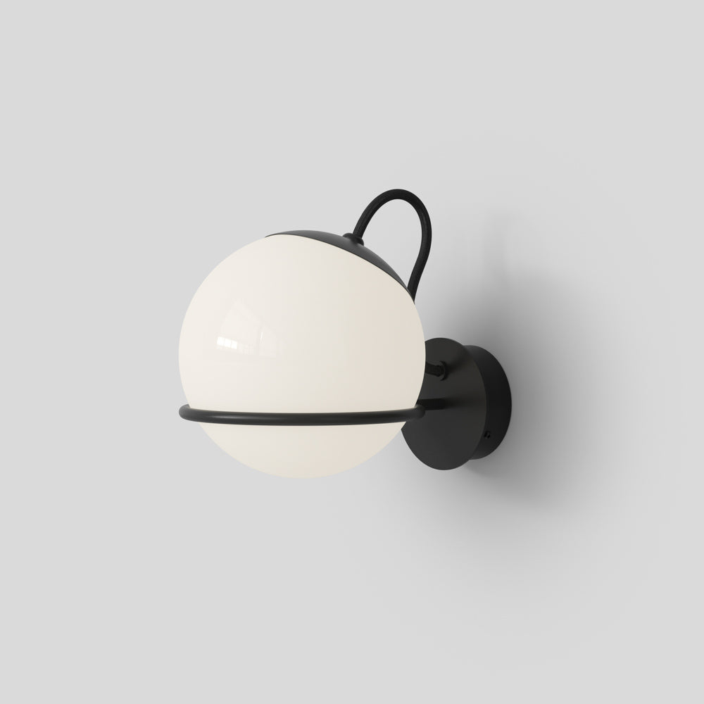 Wall-mounted spherical light fixture with white globe and black metal casing on a gray background

