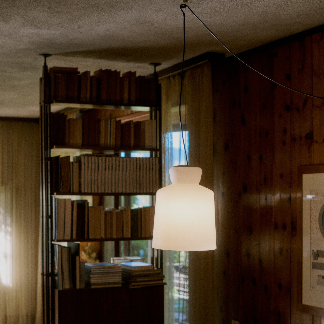 Astep SB Cinquantotto Suspension Lamp with a minimalist opaline glass sphere and sleek metal detailing, delivering soft, diffused ambient light.