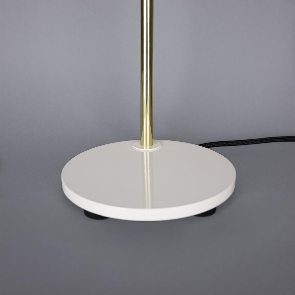 Table lamp with white base and gold pole on a gray background