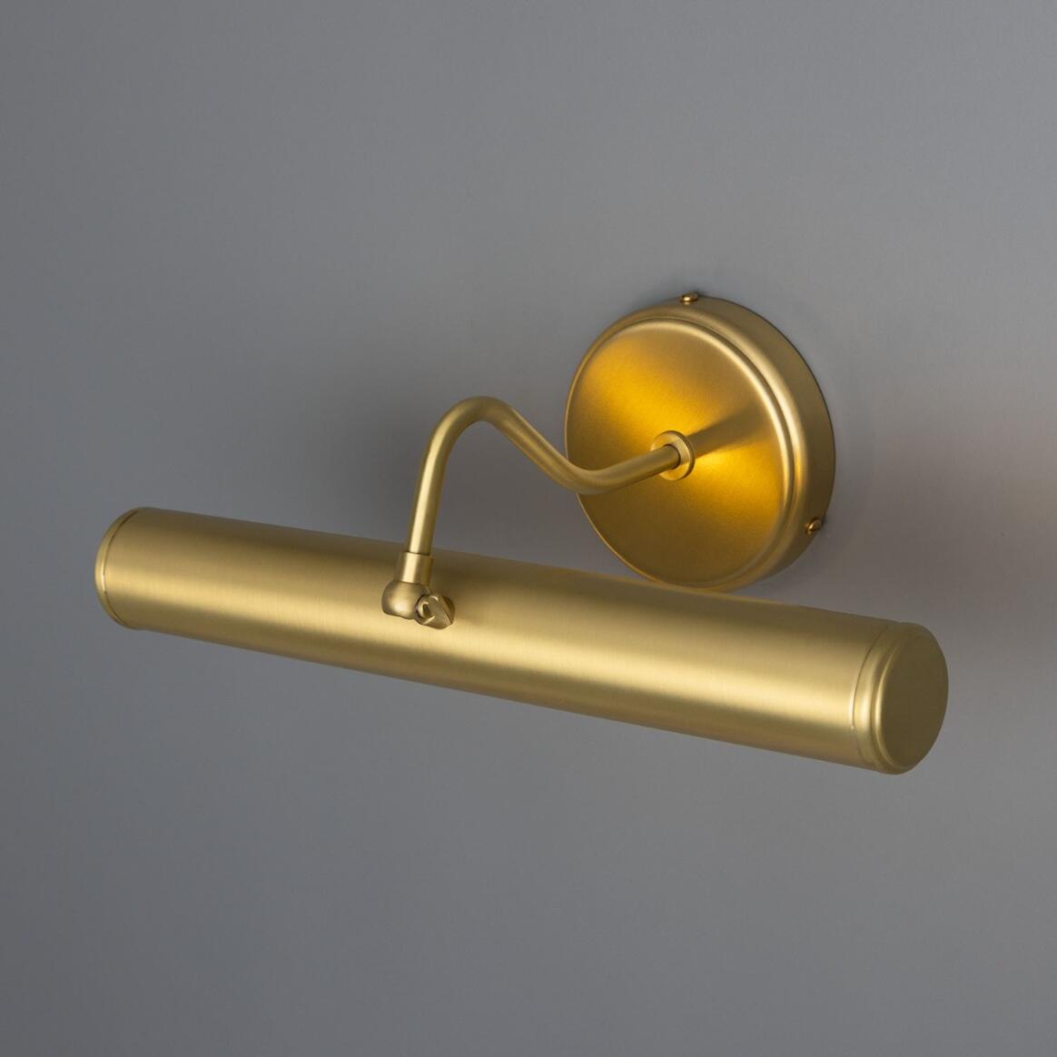 Gold wall-mounted light fixture on a gray background