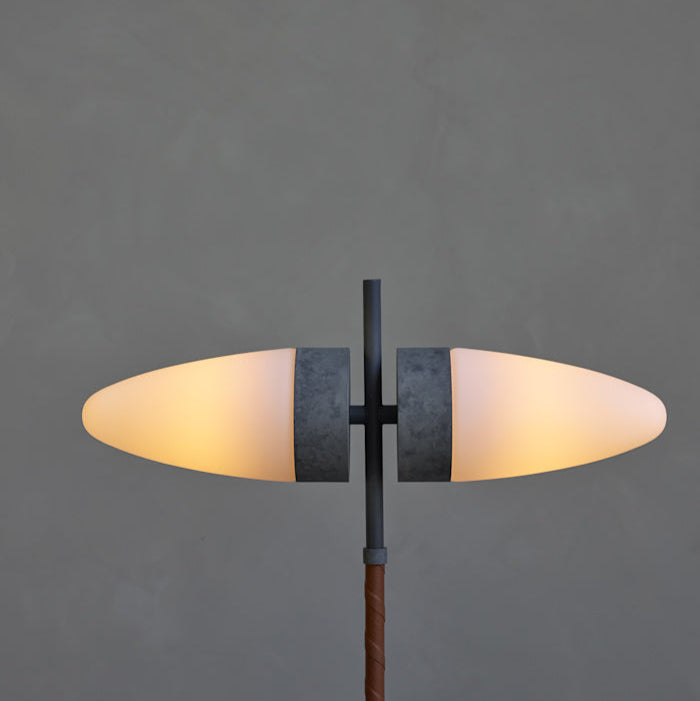 Close-up of the Bull Table Lamp’s textured ceramic base and elegant brass stem with twin opal glass shades.