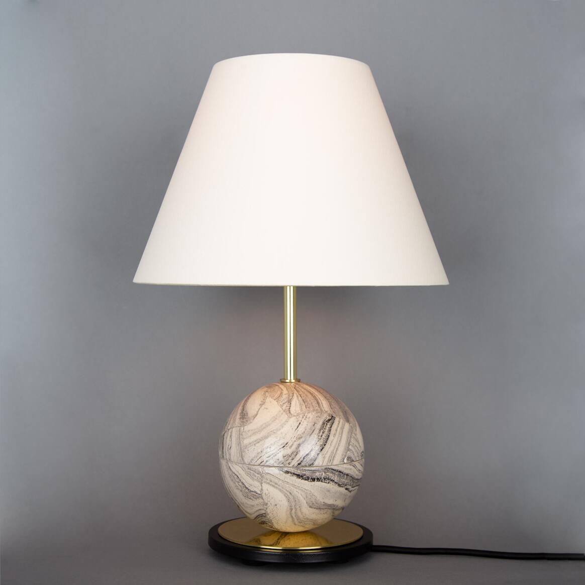 Table lamp with a marble-like base on a gray background