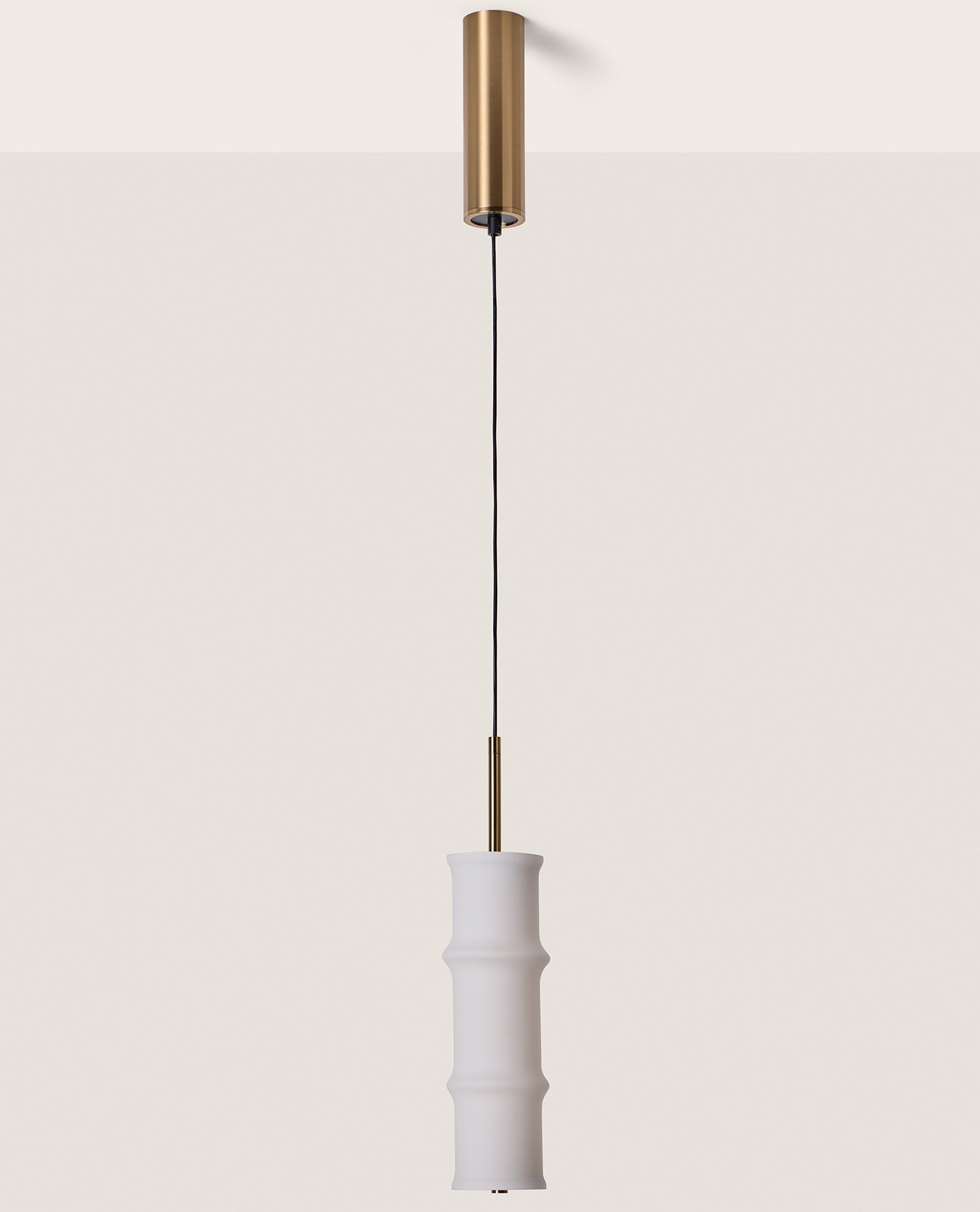 Canna Pendant Lamp by Aromas del Campo with sleek cylindrical design and warm ambient lighting for modern interior spaces.