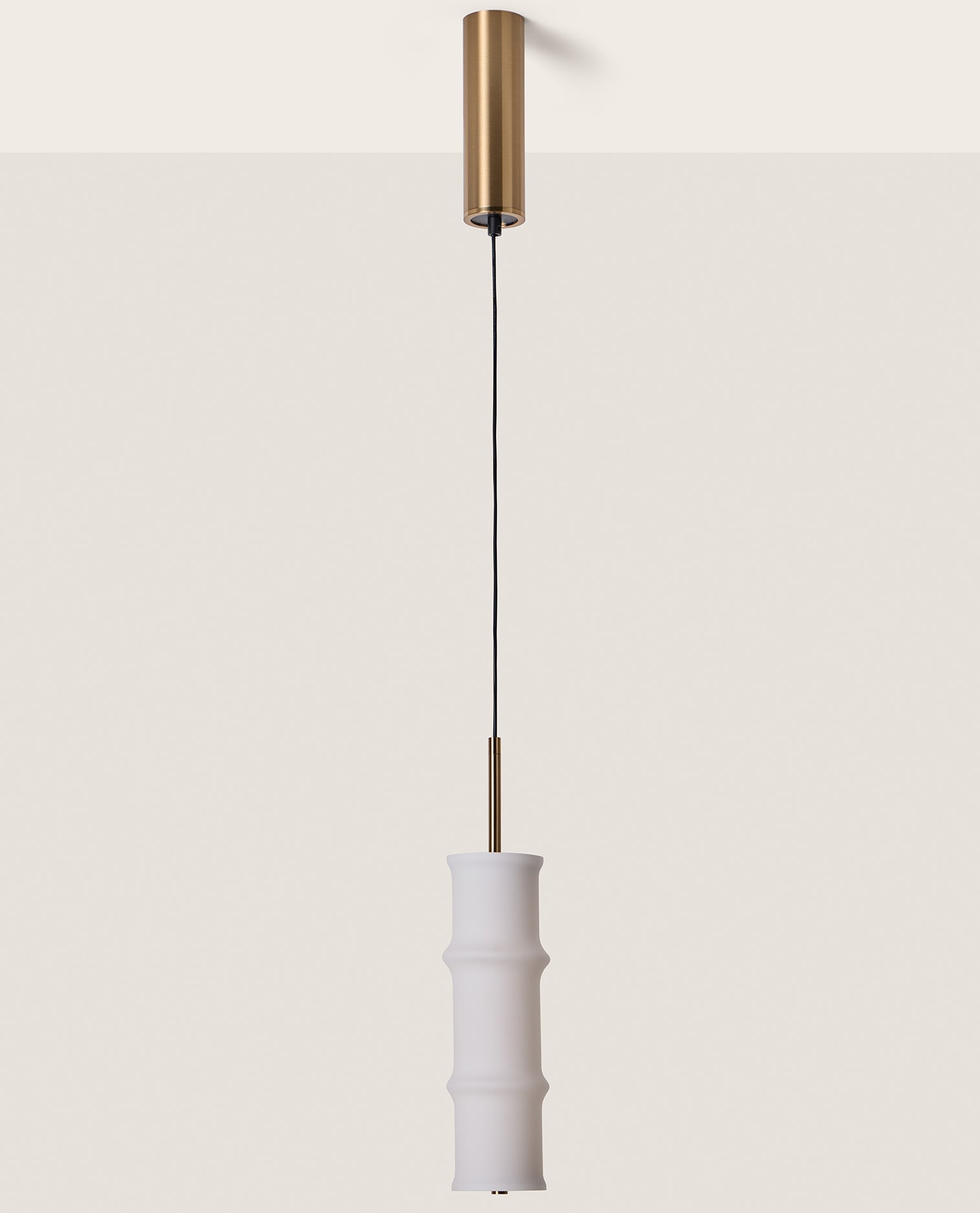 Canna Pendant Lamp by Aromas del Campo with sleek cylindrical design and warm ambient lighting for modern interior spaces.