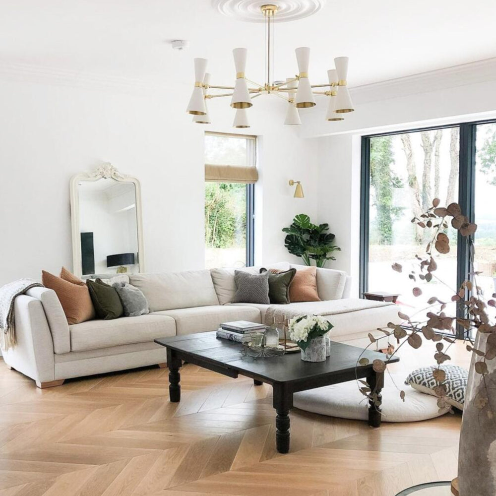 Modern living room with a white sofa, coffee table, and decorative elements.